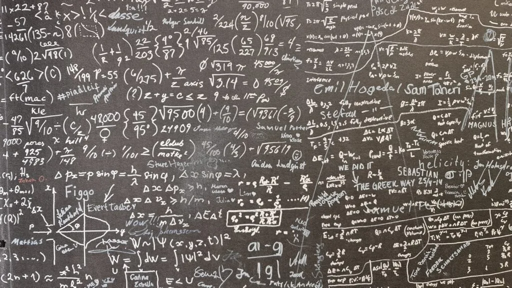 A blackboard with a lot of writing on it